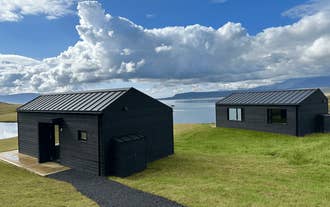 Hvammsvik Nature Resort offers cozy cabins along a fjord.