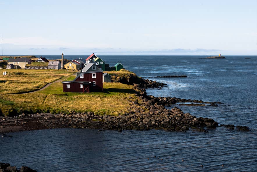 Colorful coastal houses along the rocky shore of Breidarfjordur, one of the most iconic fjords in Iceland.