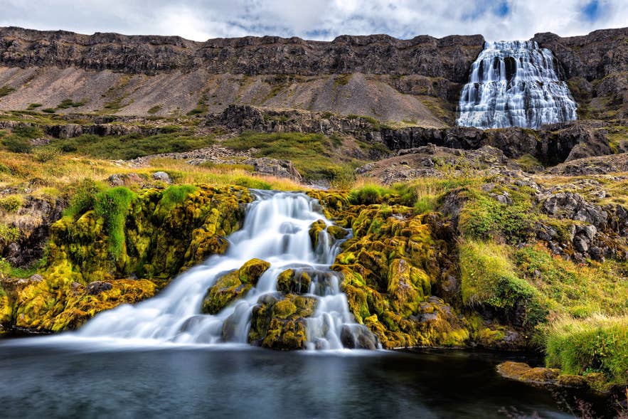 Waterfall scene of Dynjandi in the Westfjords with flowing streams and rocky cliffs