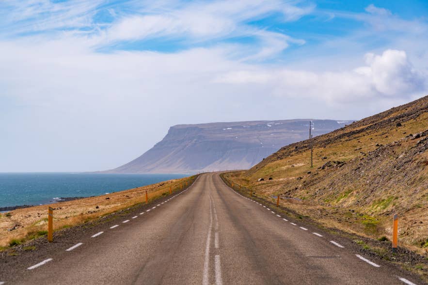 Scenic coastal road winding through Icelandic mountain landscape