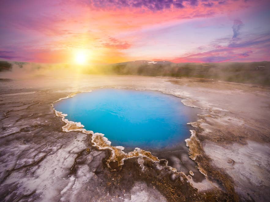 Blue geothermal hot spring in Iceland under the midnight sun
