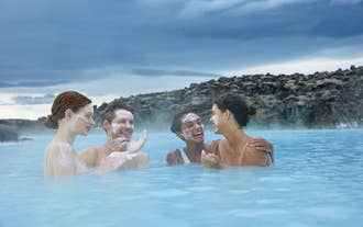 Friends enjoying silica mud mask at Blue Lagoon Spa near Reykjavik in Iceland.