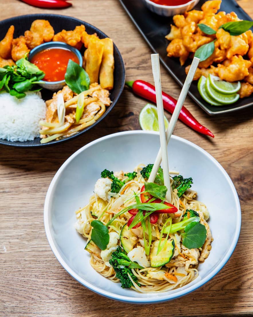 Thai stir-fried noodles and crispy fried chicken dishes served at Mjolkurbuid Food Hall in Selfoss near the Golden Circle.