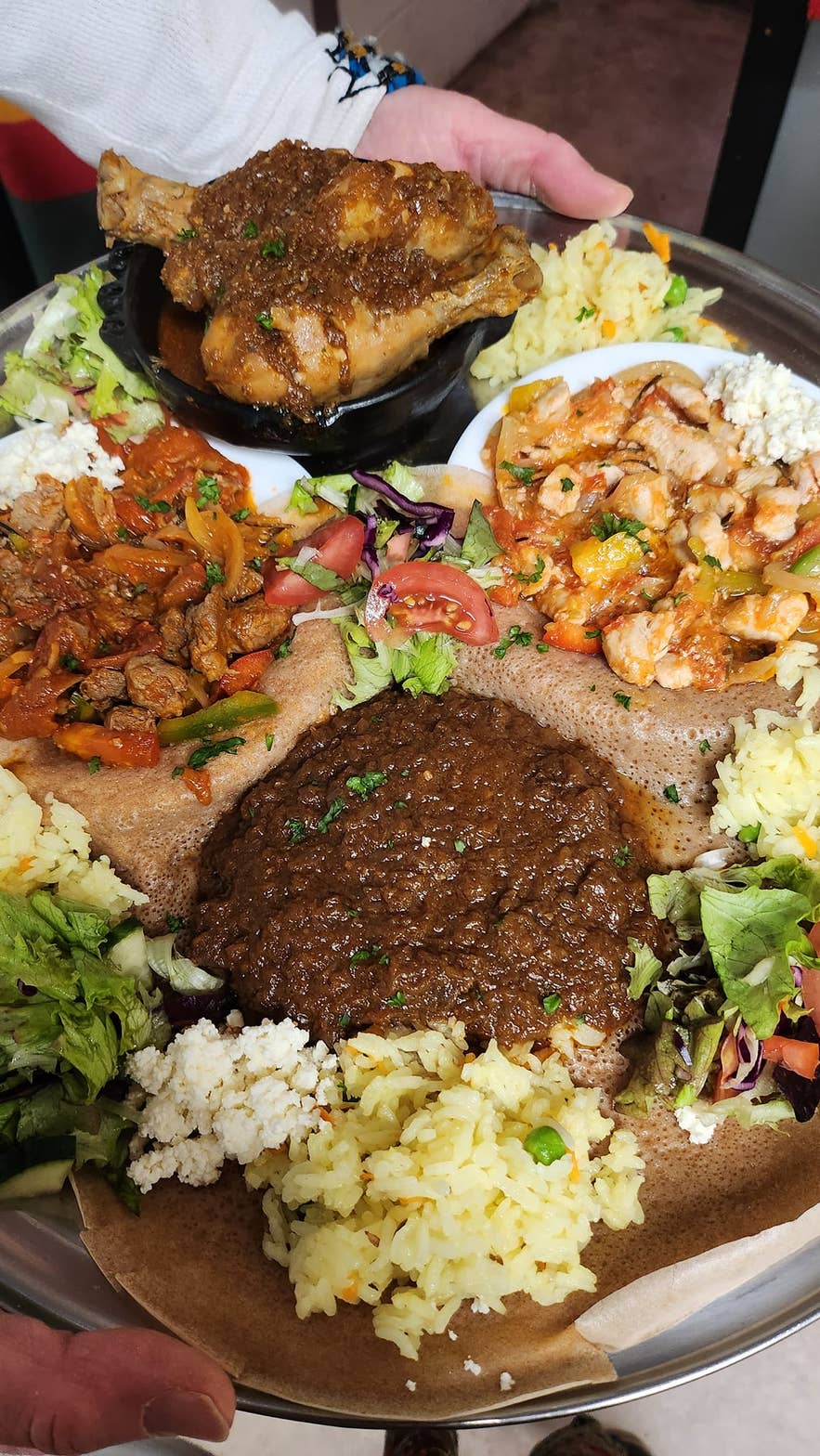 An Ethiopian combo platter with injera, lamb stew, and spiced lentils served at Minilik Restaurant in Fludir on the Golden Circle.