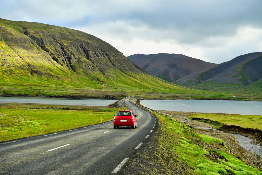 Empty stretch of the Ring Road winding through volcanic landscape on a self-drive tour in Iceland.