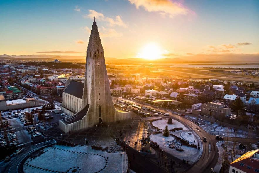 Aerial sunset view of Hallgrimskirkja Church and central neighborhoods, showcasing the beauty of Reykjavik in May.