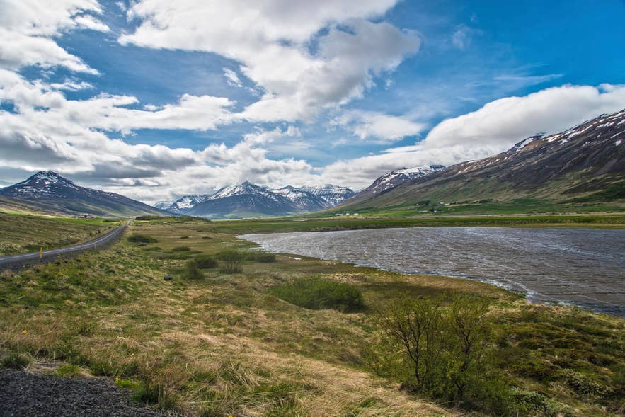 Trollaskagi Peninsula in North Iceland with dramatic mountain scenery, valleys, and fjord landscapes under blue skies Trollaskagi Peninsula in North Iceland with dramatic mountain scenery, valleys, and fjord landscapes under blue skies