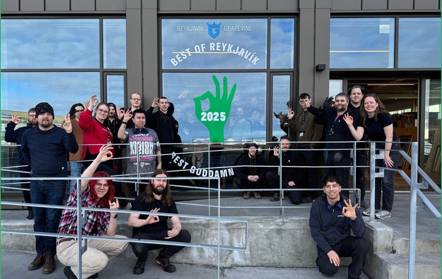 Group of staff members posing outside Godi Hirdirinn thrift store beneath a Best of Reykjavik 2025 sign in Reykjavik.