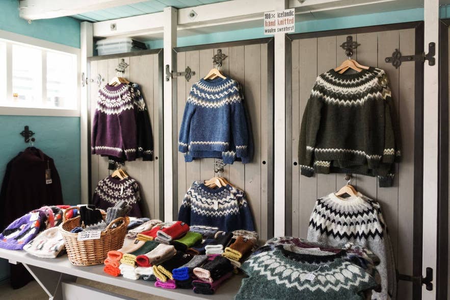 Display of Icelandic lopapeysa wool sweaters and knitted souvenirs in a shop in Iceland