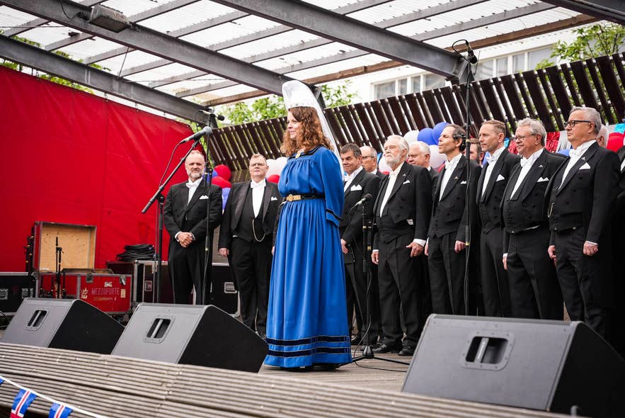 Björk Níelsdóttir as the Fjallkona of Hafnarfjordur wearing a blue kyrtill during a 2024 celebration in Iceland