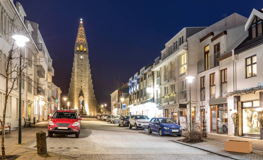 Quiet Reykjavik street at night with Hallgrimskirkja church in the background.