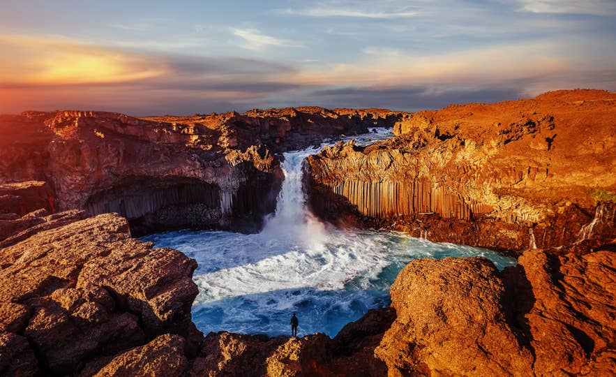 Aldeyjarfoss Waterfall flowing between tall basalt columns in North Iceland.