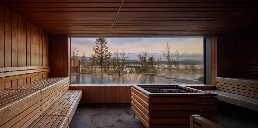 Bathers relaxing at Forest Lagoon, a wooded geothermal spa near Akureyri in North Iceland.