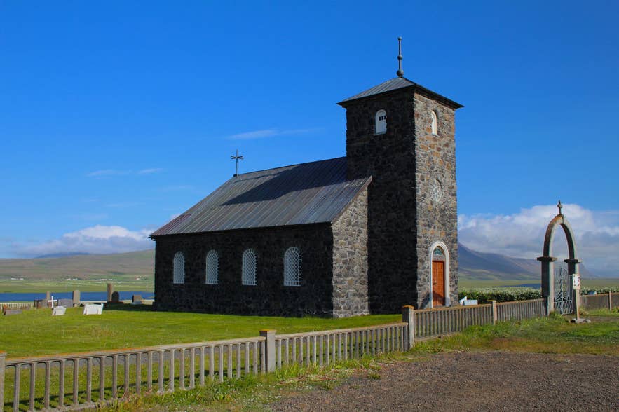 Thingeyrarkirkja Church in North Iceland under a blue sky.