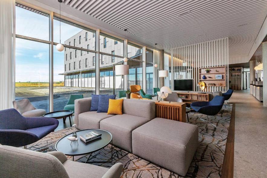 Modern interior of the Courtyard by Marriott Reykjavik Keflavik Airport with a comfortable lounge seating area.