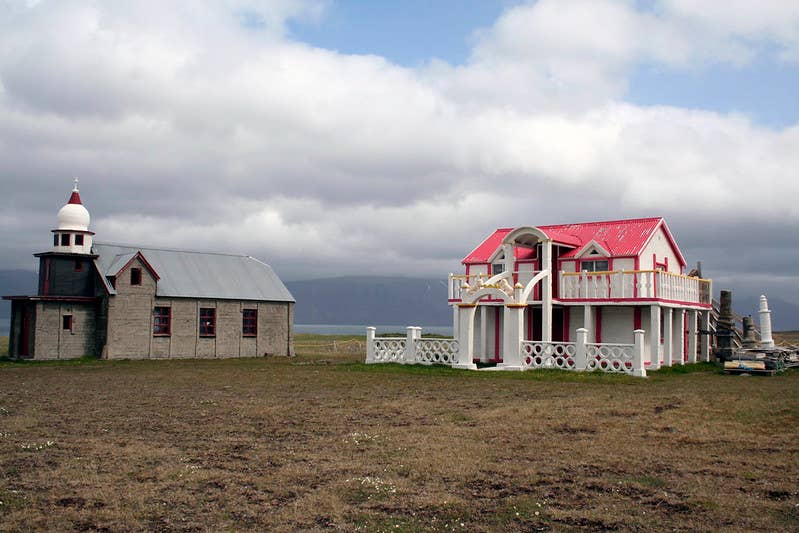 Samuel Jónsson Art Farm in Selárdalur Valley, Iceland, with folk‑style sculptures set against grassy hills.