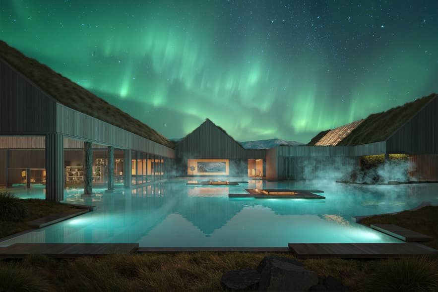 Reykjabod Hot Springs geothermal lagoon glowing beneath the northern lights.