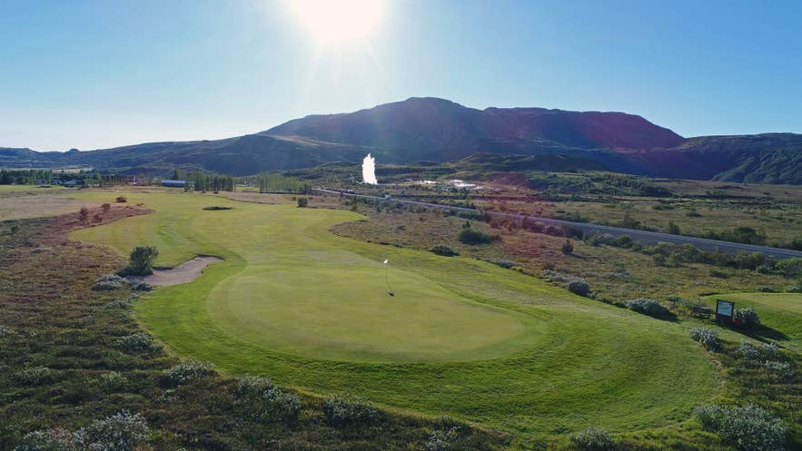 The Geysir Golf Course winds through green fairways beneath volcanic hills in Haukadalur Valley, Iceland.