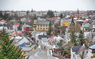 Snow-covered town in Iceland with colorful houses and winter scenery viewed from above.