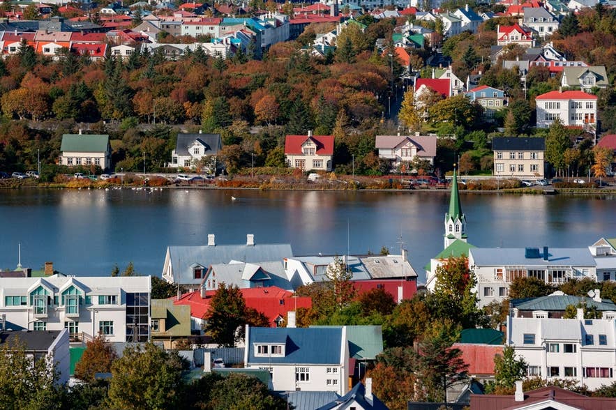 Houses by Lake Tjornin in central Reykjavik, Iceland.
