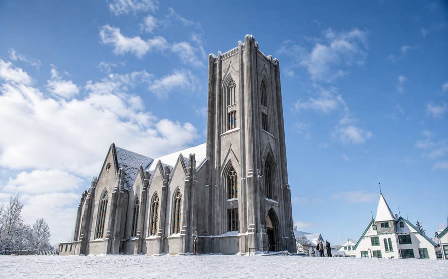 Landakotskirkja, a gray stone cathedral in Iceland, surrounded by snow in winter.
