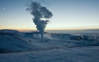 A plume of geothermal steam rises over the snowy Krafla area near Lake Myvatn in North Iceland.