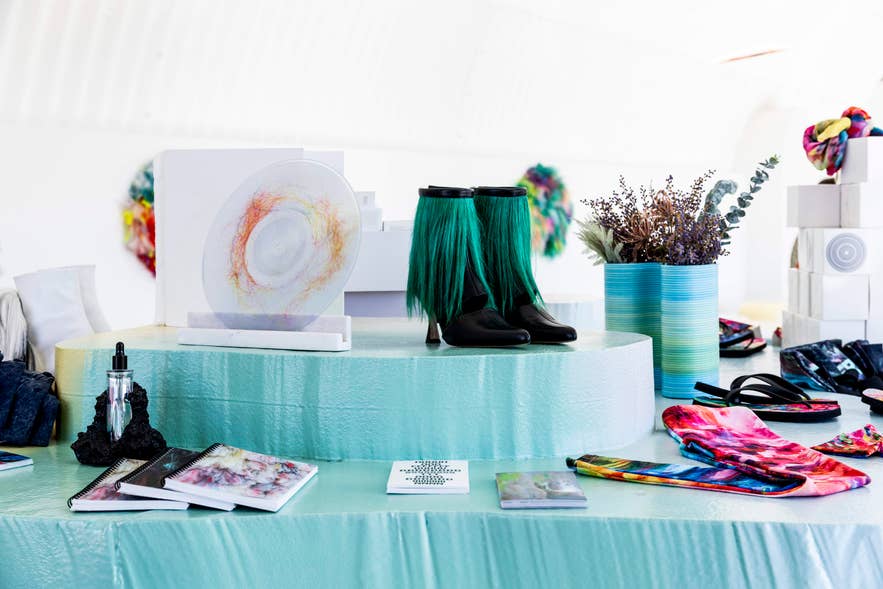 Hair-covered boots, colorful notebooks, and design objects on display at the Hofudstodin design shop by artist Shoplifter.