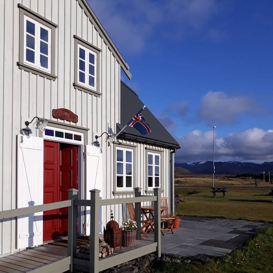 Gilbakki Kaffihus cafe building with Icelandic flag and mountain views in West Iceland