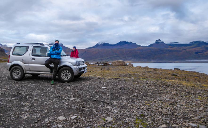 A car driving along Iceland's Ring Road through open countryside.