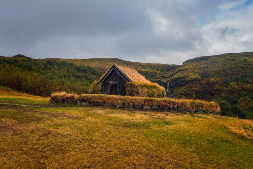Restored Icelandic turf house at the Commonwealth Farm in South Iceland, with grass roof, built from sod during early settlement.