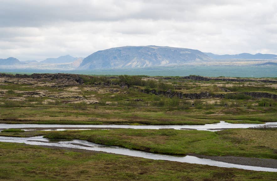View of the Lögberg area and volcanic rock formations in Thingvellir National Park, Iceland View of the Lögberg area and volcanic rock formations in Thingvellir National Park, Iceland
