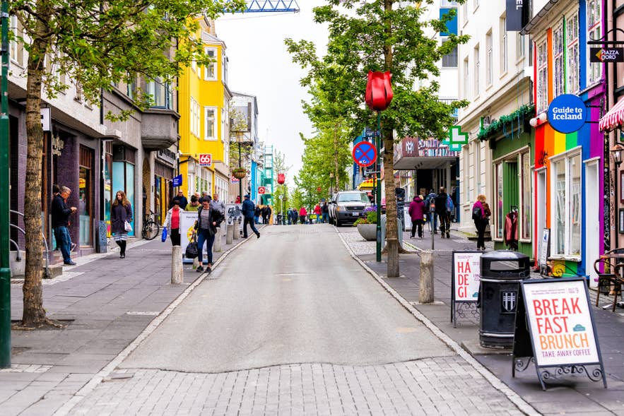 Travelers walking along Laugavegur shopping street in downtown Reykjavik.