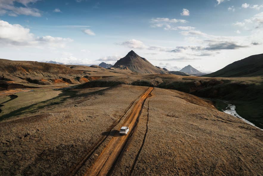 A 4x4 traveling on a rugged F-road through Iceland's remote Highlands. A 4x4 traveling on a rugged F-road through Iceland's remote Highlands.