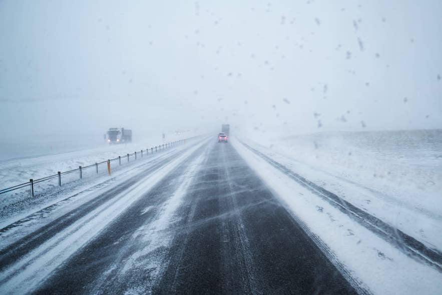 Dramatic, stormy weather over an Icelandic landscape, a reminder to check road and weather alerts before driving
