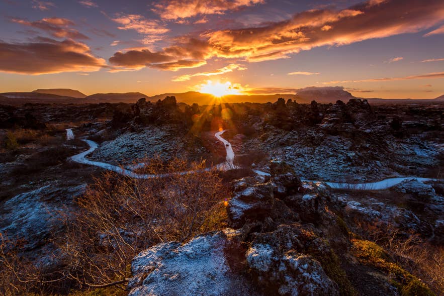 The sun sets over the lava formations and walking paths of Dimmuborgir near Lake Myvatn in North Iceland.