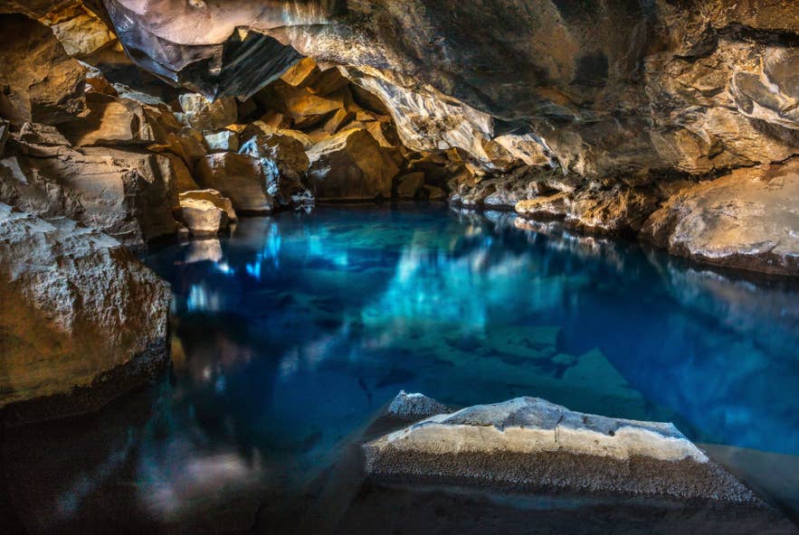 The blue geothermal spring glows inside Grjotagja Cave, a Game of Thrones filming location in North Iceland. The blue geothermal spring glows inside Grjotagja Cave, a Game of Thrones filming location in North Iceland.