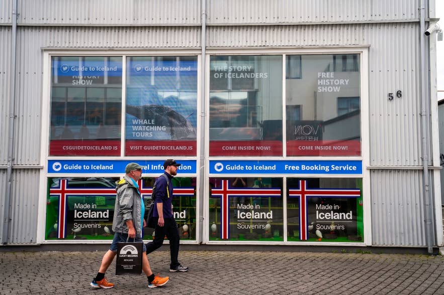 Pedestrians passing the Made in Iceland Souvenirs storefront at Laugavegur 56 in Reykjavik