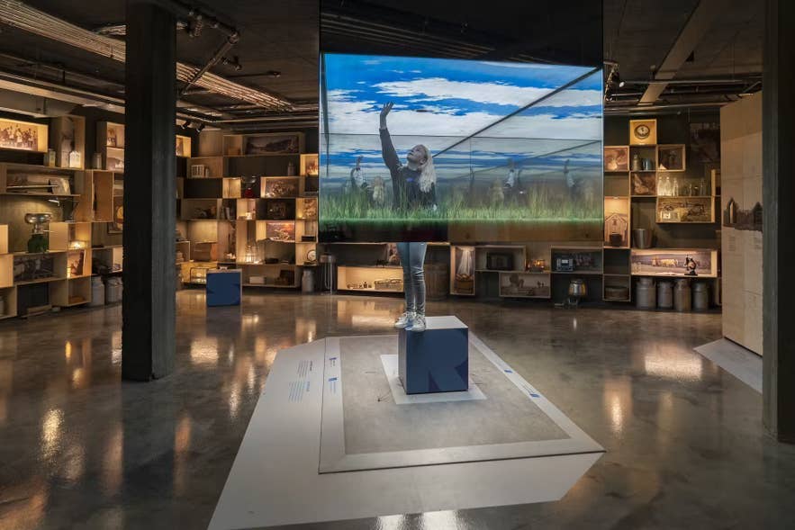Visitor exploring an interactive display at Skyrland Museum in Iceland