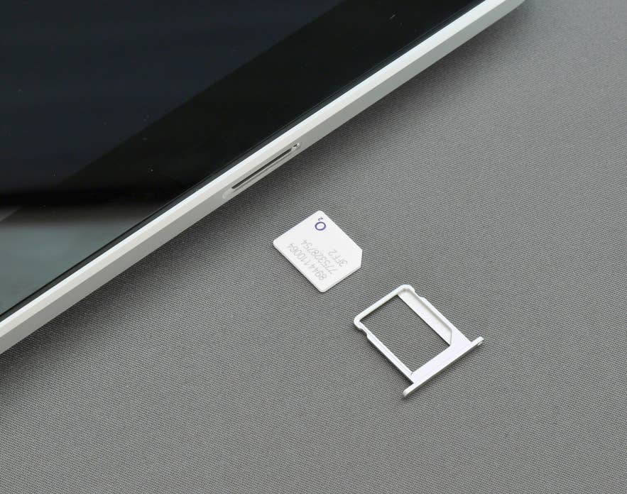 A SIM card being inserted into a smartphone for use on an Iceland road trip.