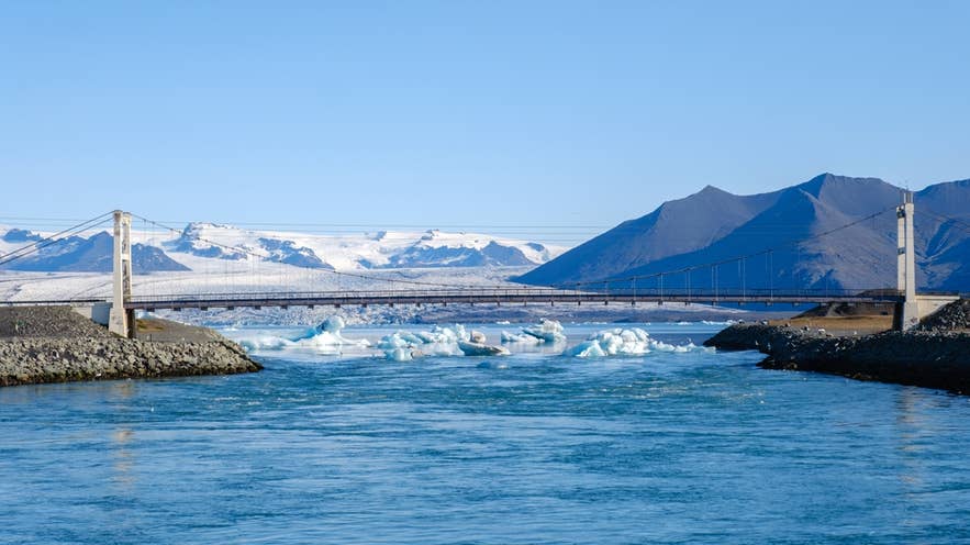 Jokulsarlon bridge with Breidamerkurjokull glacier and floating icebergs in Iceland
