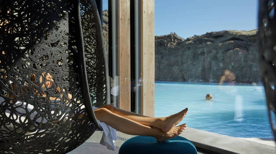 Woman relaxing in a hanging chair at the Retreat Spa at the Blue Lagoon in Iceland.