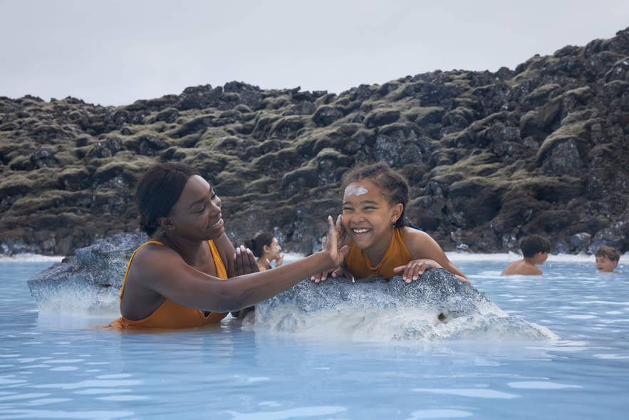 Woman enjoying privacy by a bridge at the Blue Lagoon in Iceland.