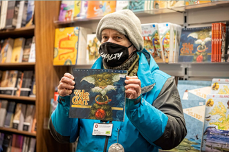 Your guide at the bookstore, immersed in Yule Cat tales, sharing the enchanting folklore that adds magic to the Reykjavik cat walking tour.