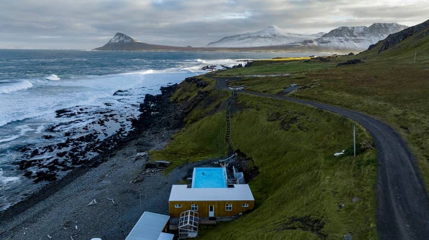 Krossneslaug geothermal pool with hot water on the beach next to Greenland sea on the Icelandic coast.