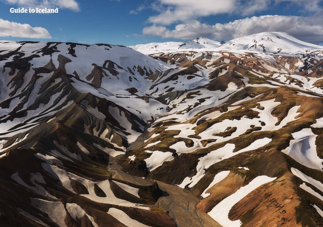 Snow lingers on the multicoloured rhyolite peaks of Landmannalaugar in the Icelandic Highlands.