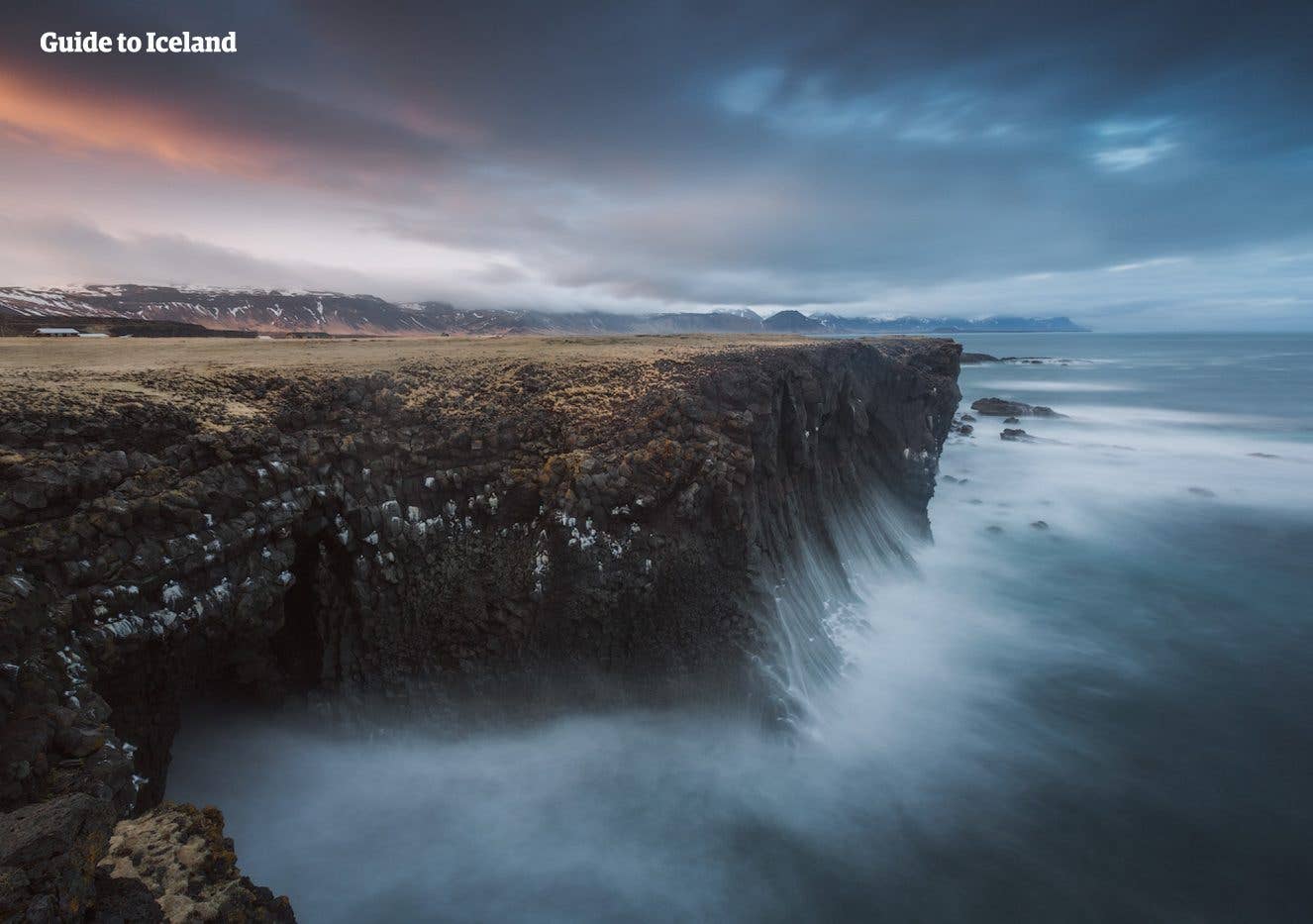 Basalt sea cliffs drop into the Atlantic near Arnarstapi on the Snæfellsnes Peninsula, West Iceland.