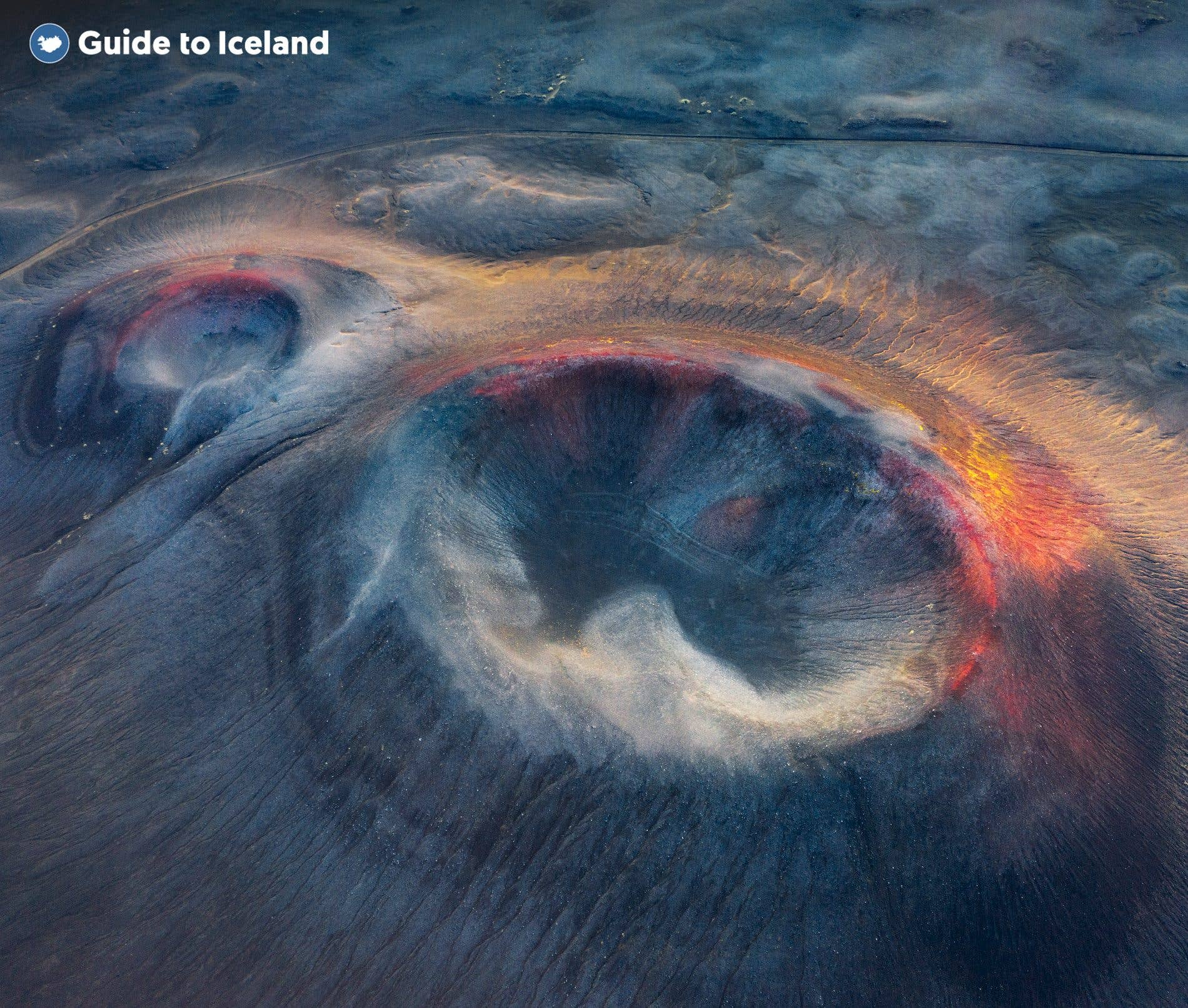 Twin volcanic craters with rust-red rims seen from the air in the Highlands of South Iceland.