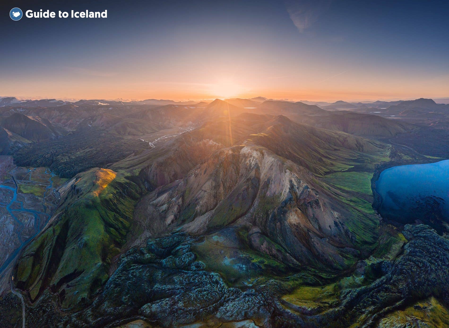 The sun sets behind the Stútur crater and Frostastaðavatn lake in the Landmannalaugar area of the Highlands, Iceland.