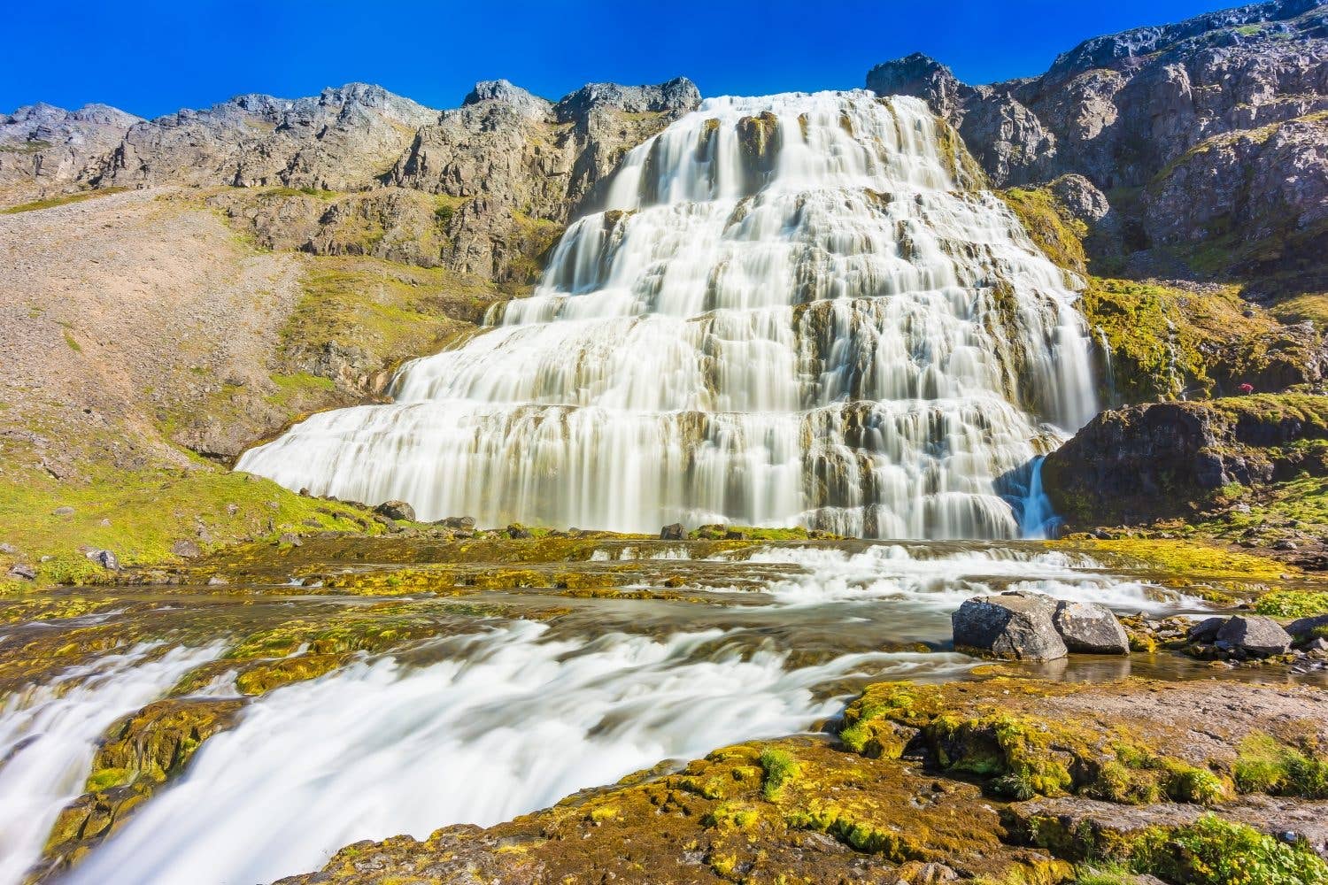 The fan-shaped Dynjandi waterfall cascades down a mountainside in the Westfjords of Iceland.