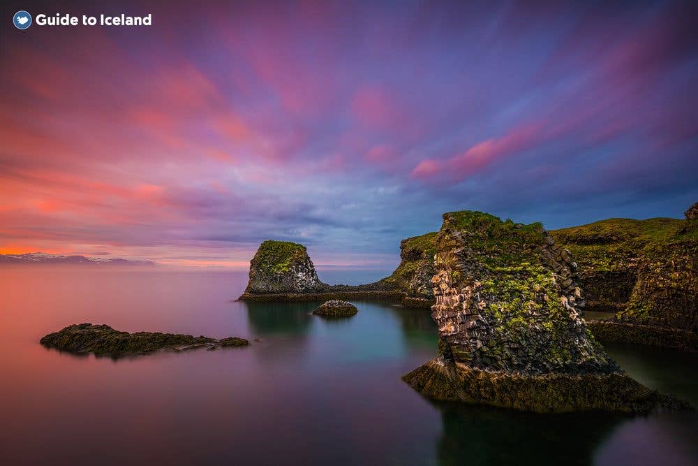 The midnight sun colours the sky above the sea cliffs at Hellnar on the Snæfellsnes Peninsula, West Iceland.